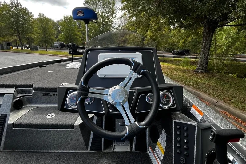Slide: The Image of 2024 Ranger Z518 Ranger Cup boat dashboard with steering wheel and controls. - 6