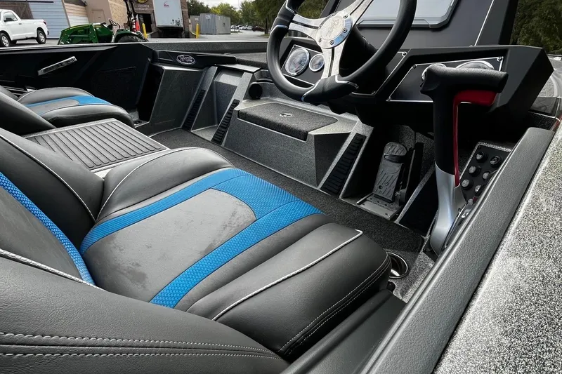 Slide: The Image of 2024 Ranger Z518 Ranger Cup Equipped interior with black and blue seating, steering wheel, and controls. - 8