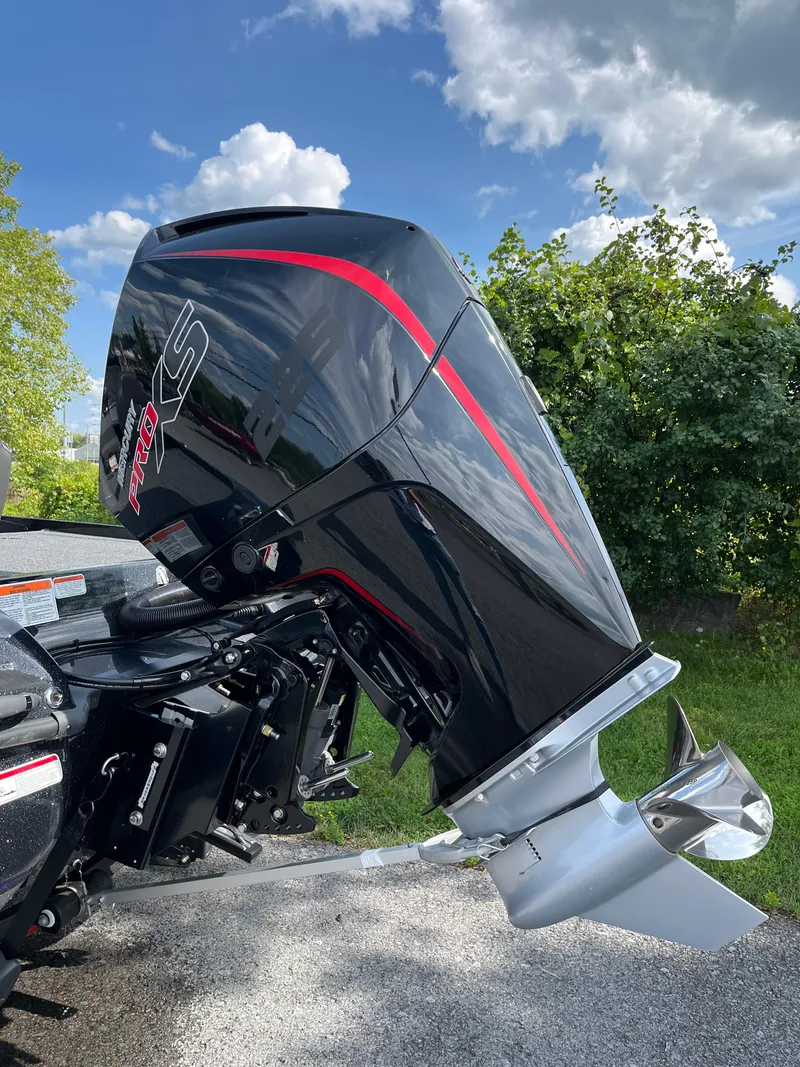 Slide: The Image of 2024 Nitro Z20 Pro outboard motor, sleek black design with red accents, outdoors. - 3