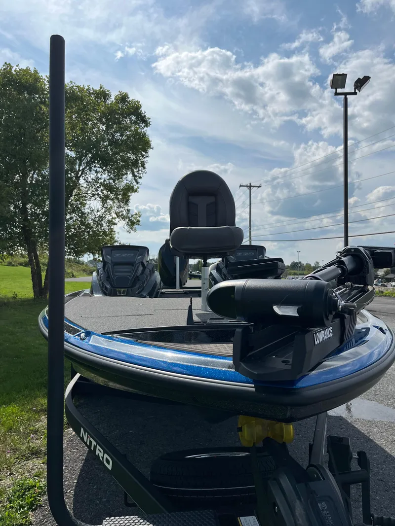 Slide: The Image of 2024 Nitro Z20 Pro boat under a partly cloudy sky, parked outdoors. - 4