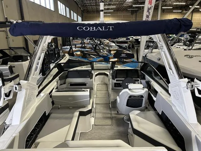Slide: The Image of 2024 Cobalt R4 Surf boat interior with seating and helm in showroom. - 2