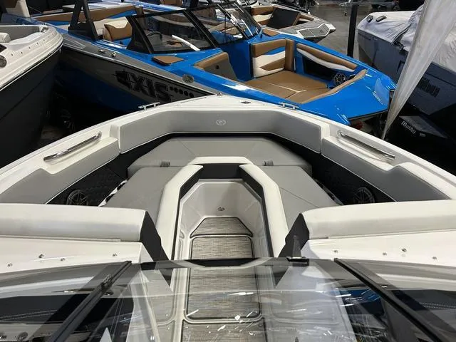 Slide: The Image of 2024 Cobalt R4 Surf boat interior at a showroom, featuring sleek seating and modern design. - 3