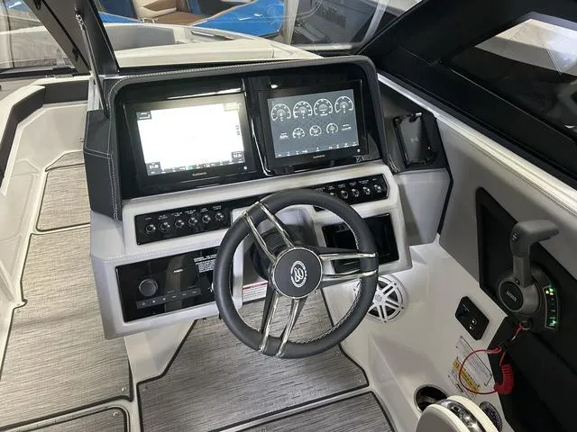 Slide: The Image of 2024 Cobalt R4 Surf boat dashboard with modern controls and dual display screens. - 4