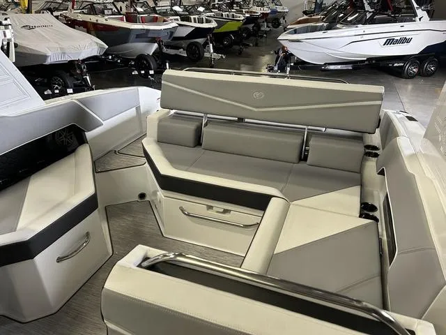 Slide: The Image of 2024 Cobalt R4 Surf boat interior with sleek seating in a showroom. - 6