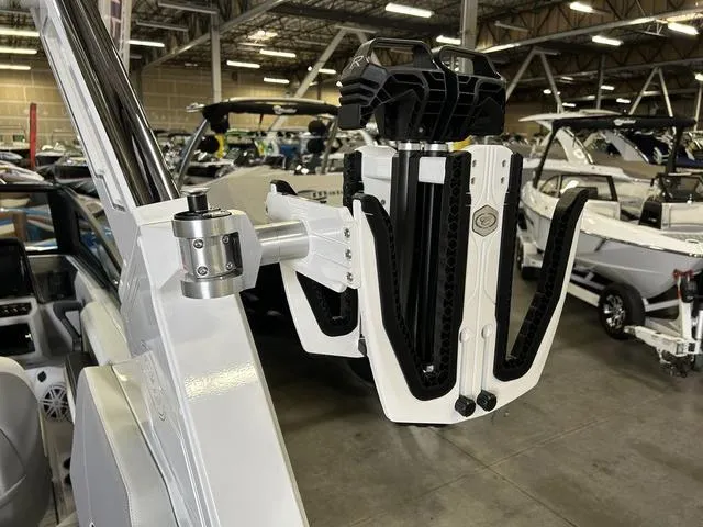 Slide: The Image of 2024 Cobalt R4 Surf boat with advanced wakeboard rack in showroom. - 9