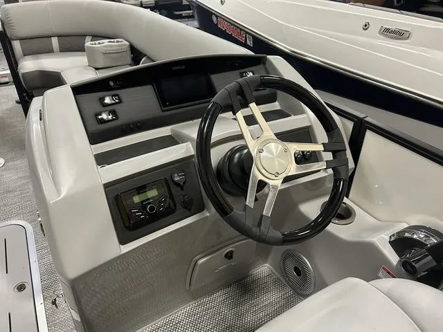 Slide: The Image of 2024 Bennington 23 LFB boat dashboard with steering wheel and controls. - 5