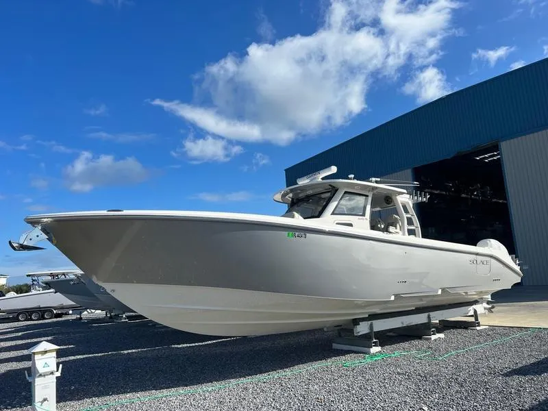 The Image of 2022 Solace 41 CS boat displayed outdoors under a clear blue sky. - 1