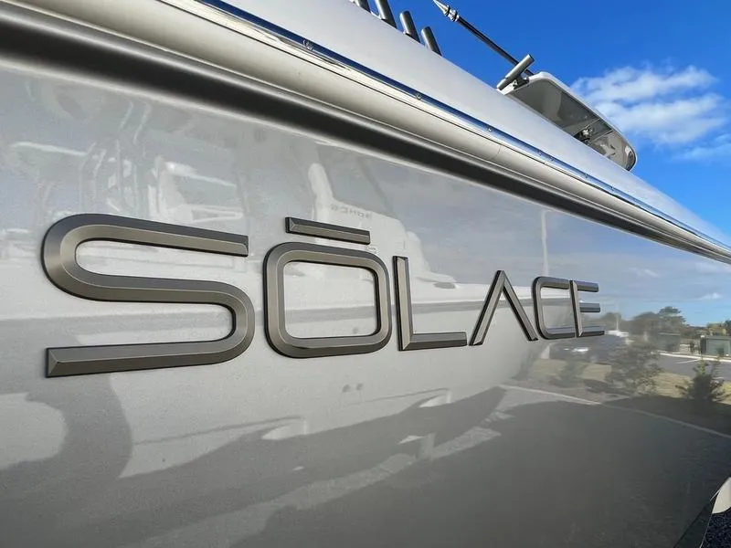 Slide: The Image of Close-up of 2022 Solace 41 CS boat logo on sleek silver surface. - 10