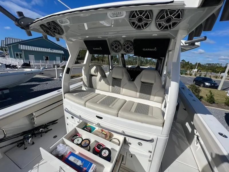 Slide: The Image of 2022 Solace 41 CS boat interior with seating, storage, and Garmin electronics. - 14