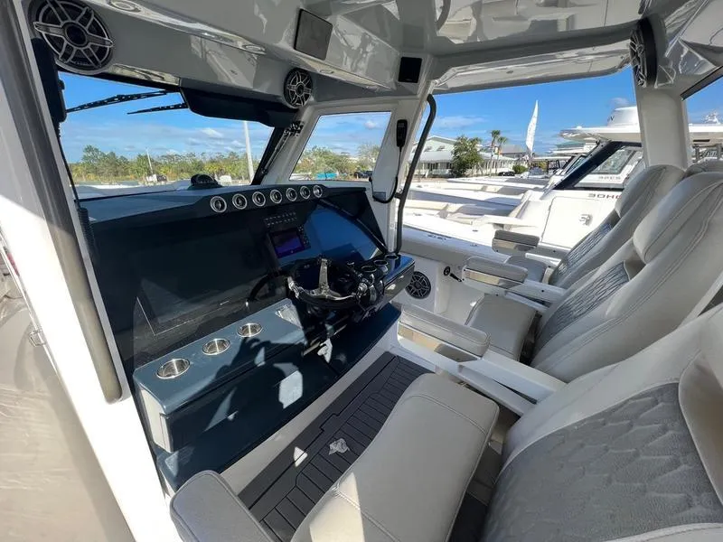 Slide: The Image of 2022 Solace 41 CS boat interior with modern dashboard and comfortable seating. - 17