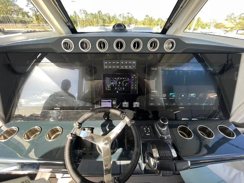 Slide: The Image of 2022 Solace 41 CS boat dashboard with advanced navigation controls and digital displays. - 19