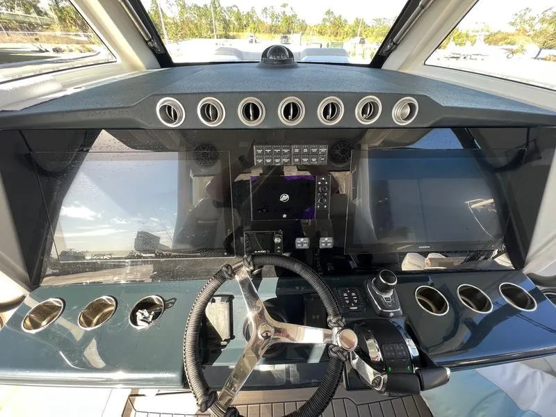 Slide: The Image of 2022 Solace 41 CS boat dashboard with steering wheel and control panel. - 20
