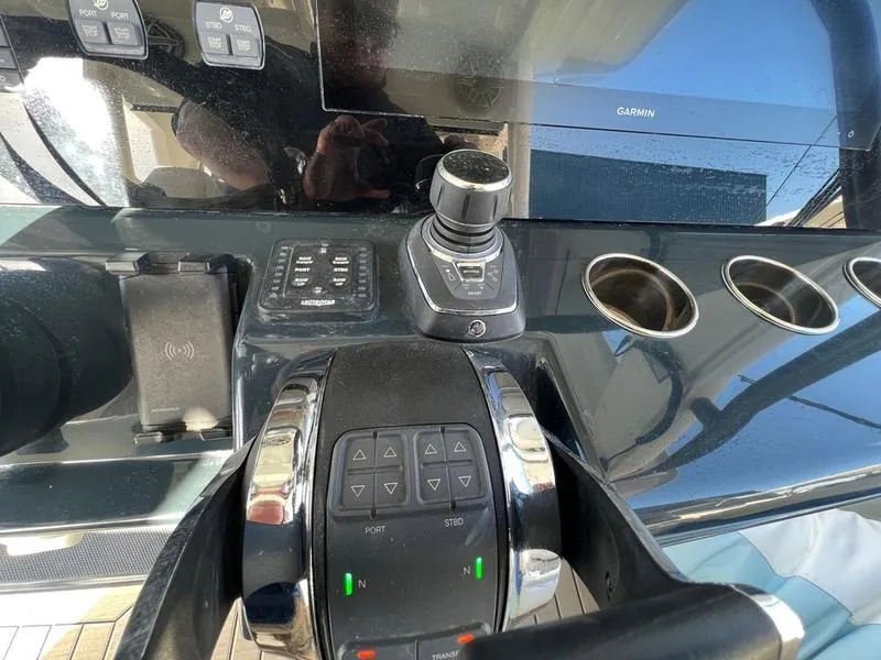Slide: The Image of 2022 Solace 41 CS boat dashboard with controls and Garmin display. - 22