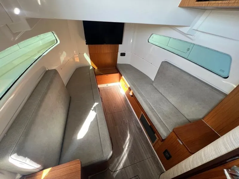 Slide: The Image of Interior of 2022 Solace 41 CS boat with modern seating and wood accents. - 26
