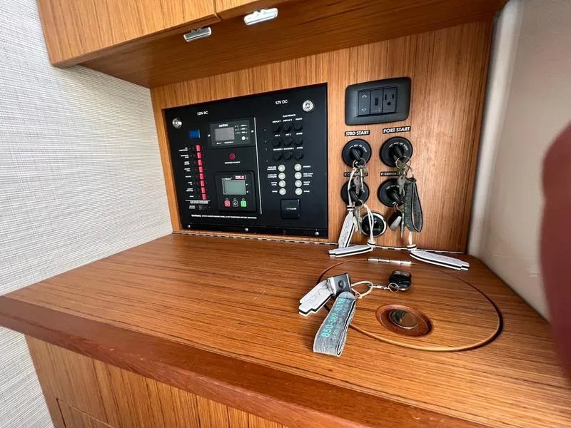 Slide: The Image of Control panel and keys on a 2022 Solace 41 CS boat interior. - 28