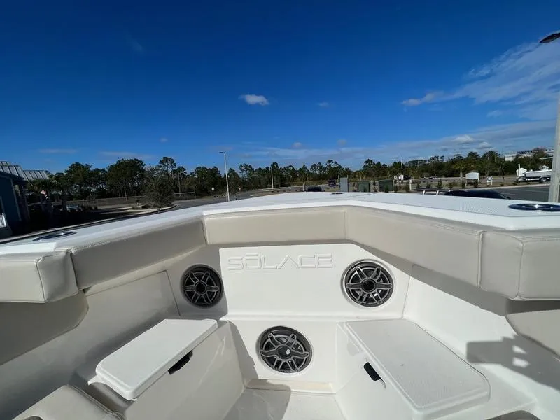 Slide: The Image of 2022 Solace 41 CS boat interior with speakers and seating under a clear blue sky. - 33