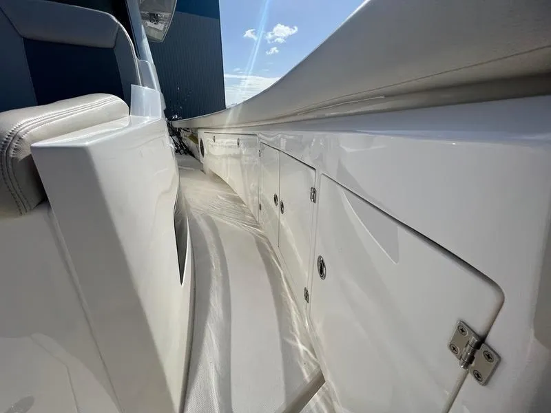 Slide: The Image of 2022 Solace 41 CS boat deck with sleek white finish and storage compartments. - 35