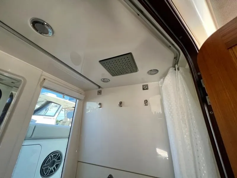 Slide: The Image of Interior of 2022 Solace 41 CS boat shower with modern fixtures and curtain. - 38