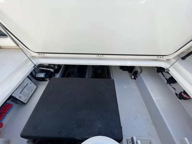 Slide: The Image of 2022 Solace 41 CS boat storage compartment with open hatch and visible equipment. - 39
