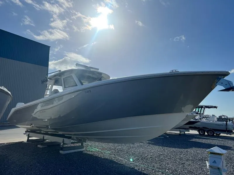 Slide: The Image of 2022 Solace 41 CS boat in sunlight, docked on gravel. - 4