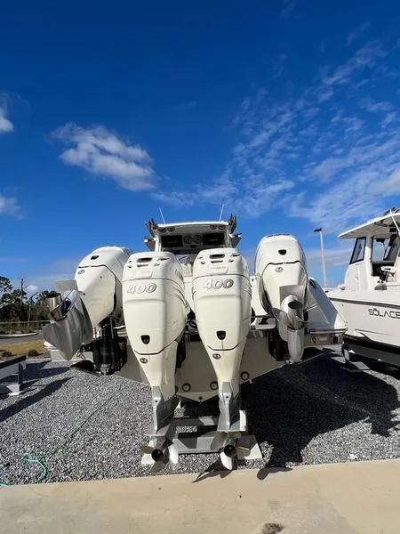 Slide: The Image of 2022 Solace 41 CS boat with powerful outboard engines under a clear blue sky. - 6
