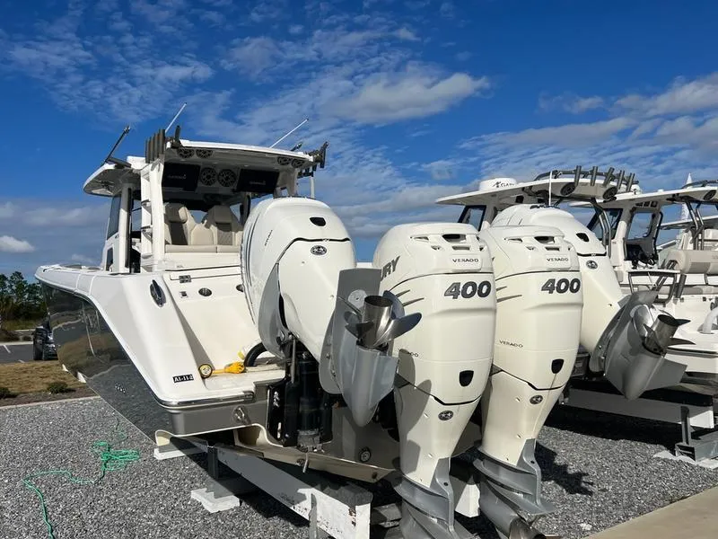 Slide: The Image of 2022 Solace 41 CS boat with triple Mercury 400 engines, docked under blue sky. - 8