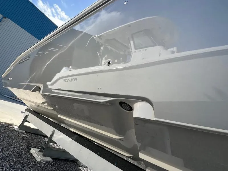 Slide: The Image of 2022 Solace 41 CS boat hull reflecting surroundings, displayed on a stand. - 9