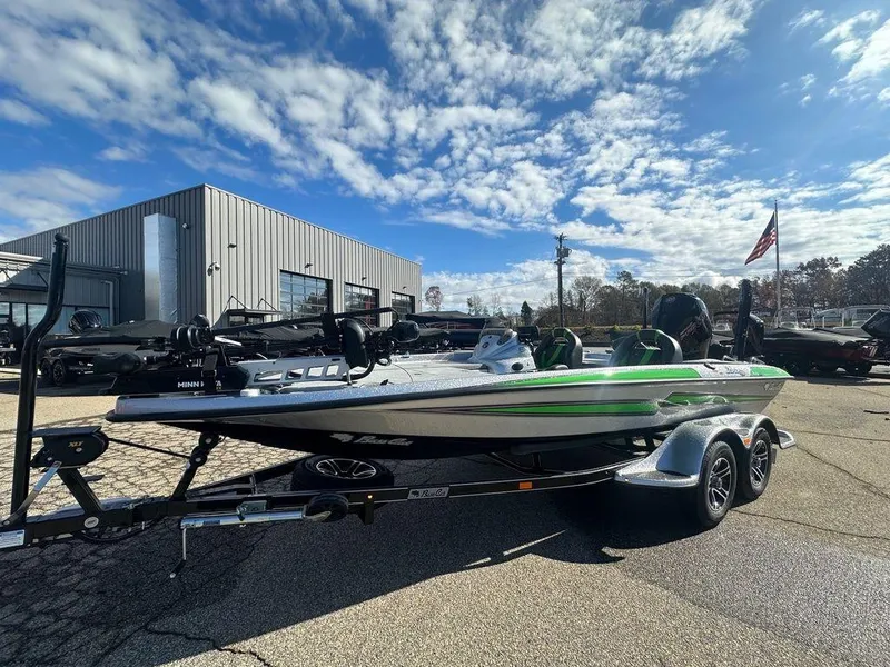 Slide: The Image of 2024 Bass Cat Sabre FTD boat on trailer under a partly cloudy sky. - 3