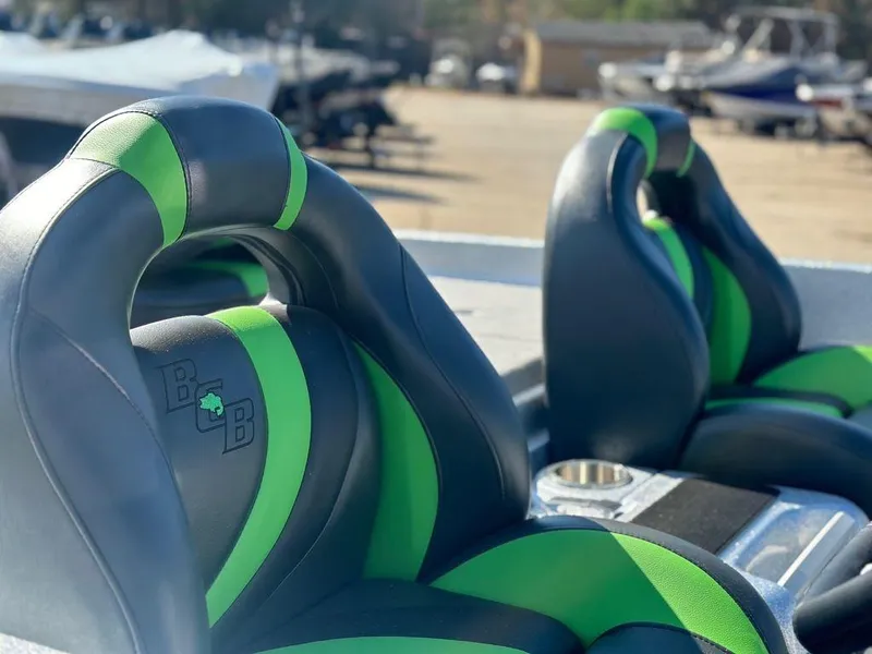 Slide: The Image of 2024 Bass Cat Sabre FTD boat seats with green and black design. - 4
