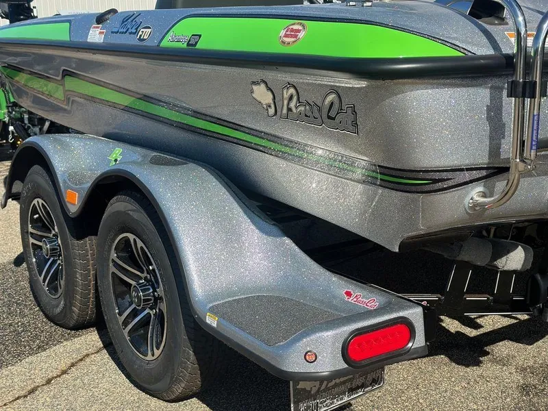 Slide: The Image of 2024 Bass Cat Sabre FTD boat with green accents on a trailer. - 5