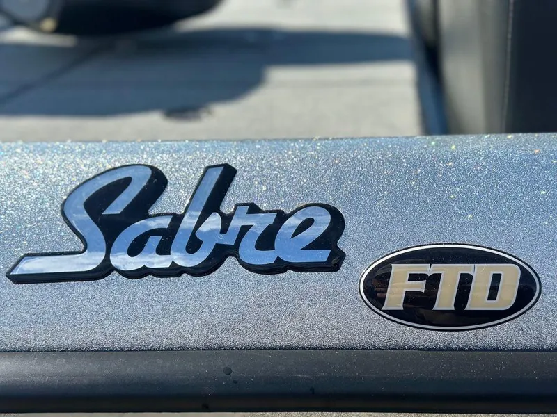 Slide: The Image of 2024 Bass Cat Sabre FTD logo on metallic surface. - 6