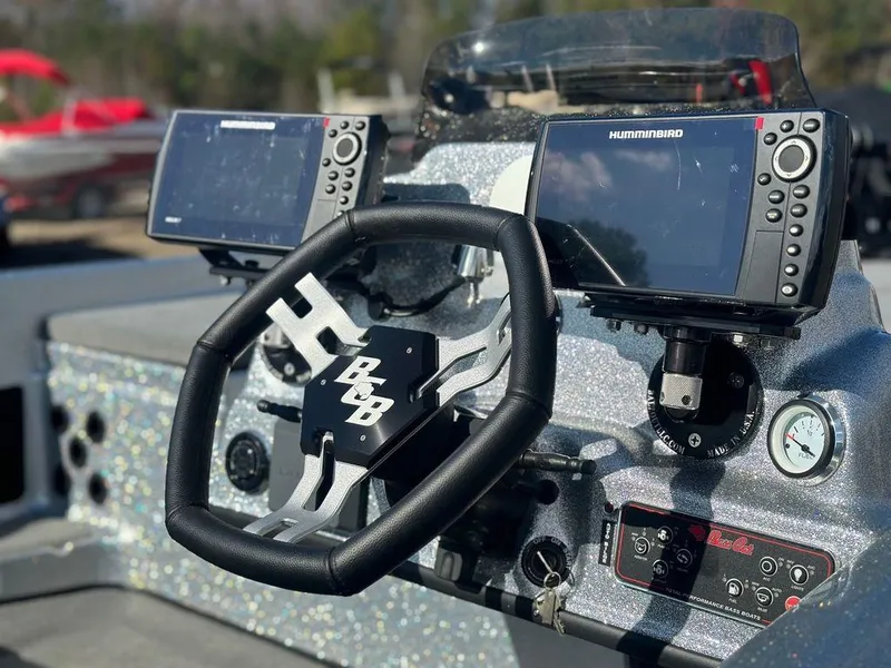 Slide: The Image of 2024 Bass Cat Sabre FTD boat dashboard with dual Humminbird fish finders. - 7