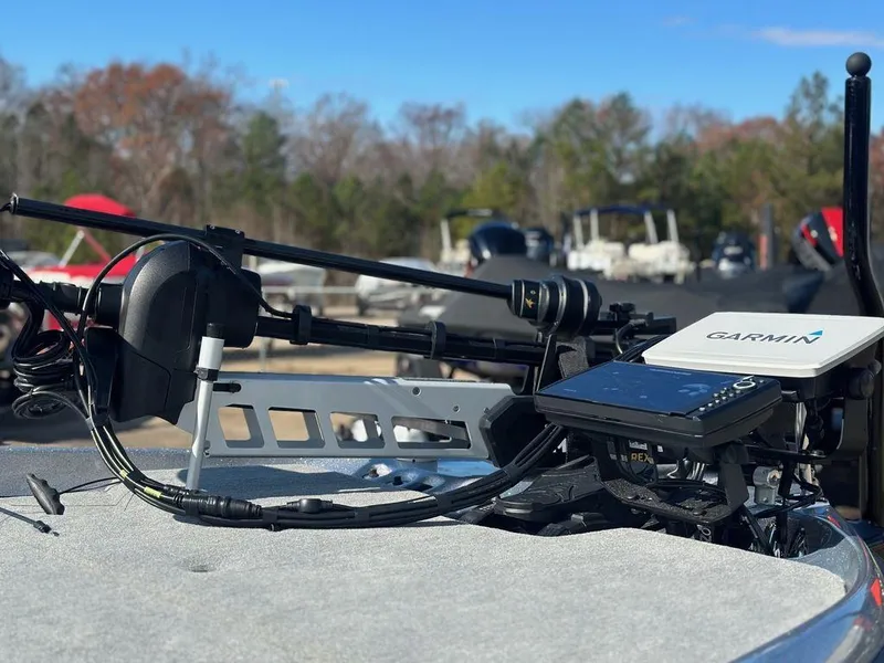 Slide: The Image of 2024 Bass Cat Sabre FTD with Garmin electronics on deck, outdoor setting. - 8