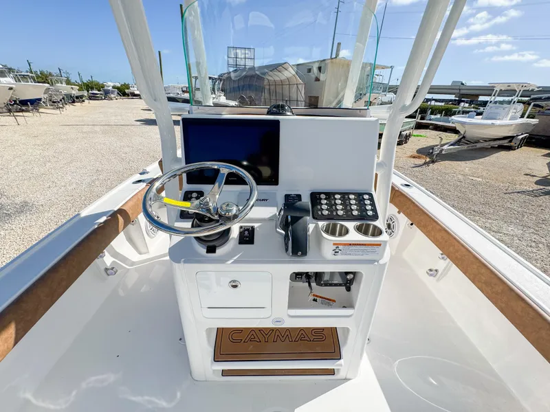 Slide: The Image of 2024 Caymas 26 HB boat console with steering wheel and navigation equipment. - 15