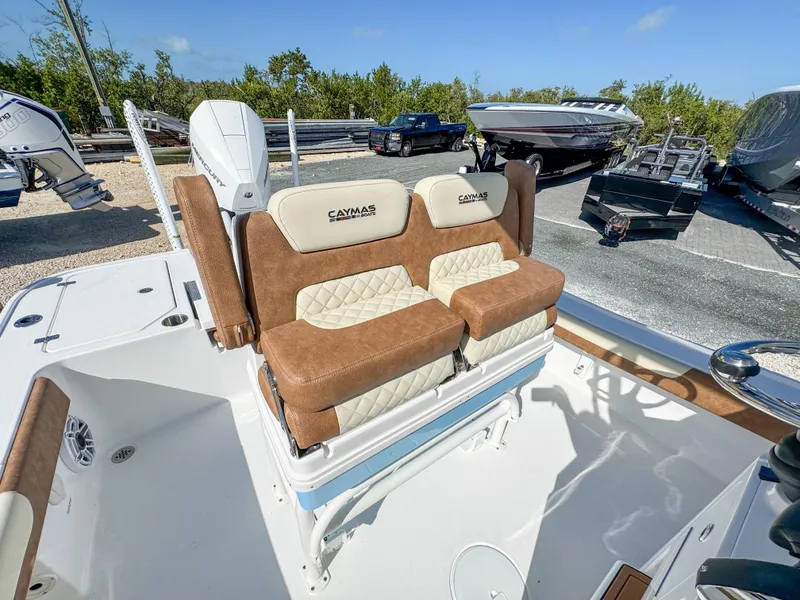 Slide: The Image of 2024 Caymas 26 HB boat with cushioned seating and modern design. - 18