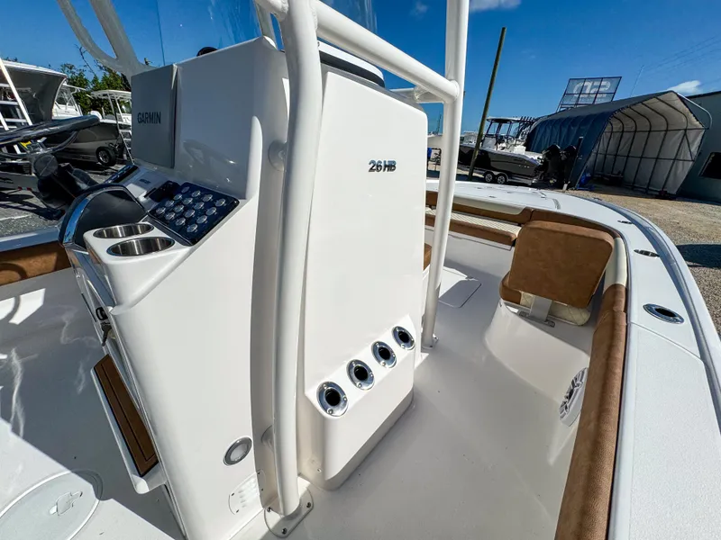 Slide: The Image of 2024 Caymas 26 HB boat interior with console and seating, showcasing modern design. - 24