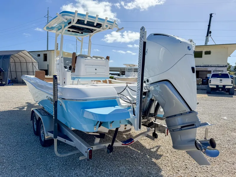 Slide: The Image of 2024 Caymas 26 HB boat on trailer, featuring powerful outboard motor. - 5