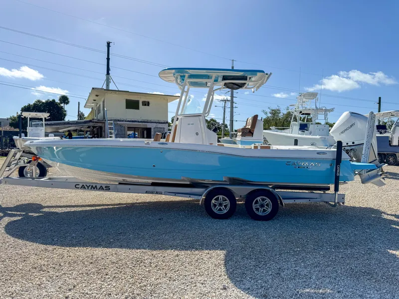 Slide: The Image of 2024 Caymas 26 HB boat on trailer, blue hull, sunny day. - 6