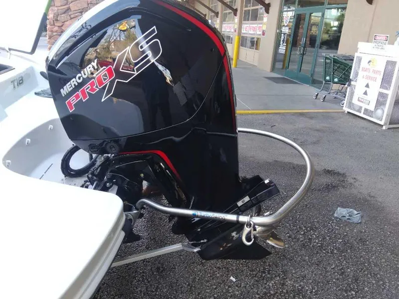 Slide: The Image of 2024 Tahoe T18 boat with Mercury Pro XS outboard motor in a parking lot. - 5