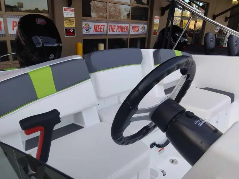 Slide: The Image of 2024 Tahoe T18 boat interior with steering wheel and seating. - 6