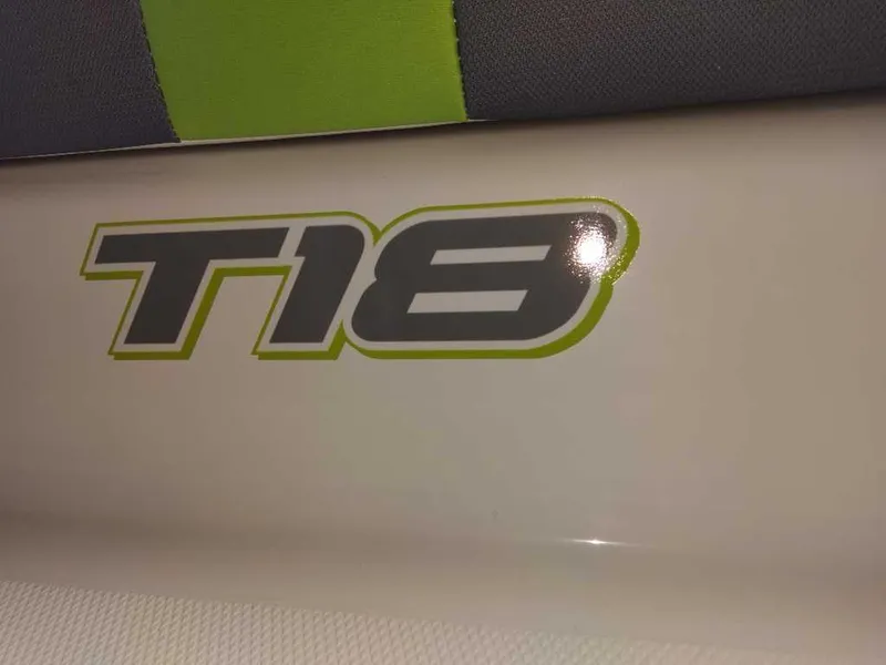 Slide: The Image of 2024 Tahoe T18 logo with green and gray accents on a boat surface. - 7