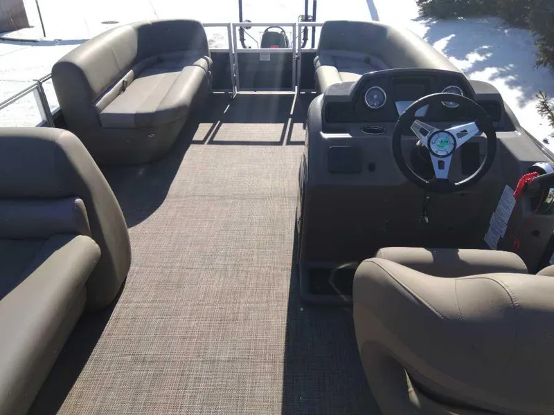 Slide: The Image of 2024 Ranger Reata 200C pontoon boat interior with spacious seating and modern steering console. - 3