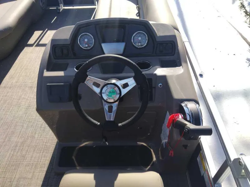 Slide: The Image of 2024 Ranger Reata 200C boat dashboard with steering wheel and controls. - 4