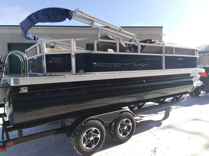 Slide: The Image of 2024 Ranger Reata 200C pontoon boat on trailer in snowy setting. - 6