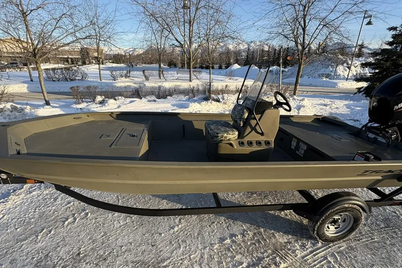 Slide: The Image of 2024 Tracker Grizzly 1860 CC boat on snowy landscape, showcasing rugged design and utility. - 26