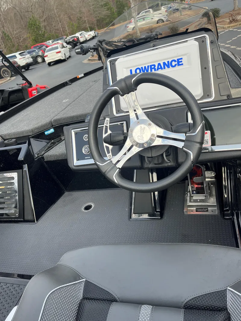 Slide: The Image of 2024 Ranger Z520R boat cockpit with steering wheel and Lowrance display. - 2