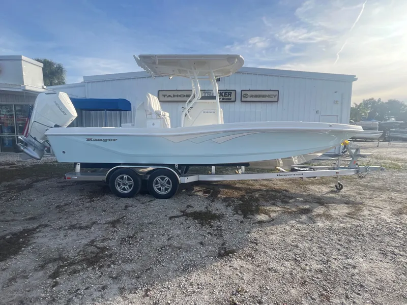 The Image of 2024 Ranger 2600 Bay boat on a trailer in front of a dealership. - 0