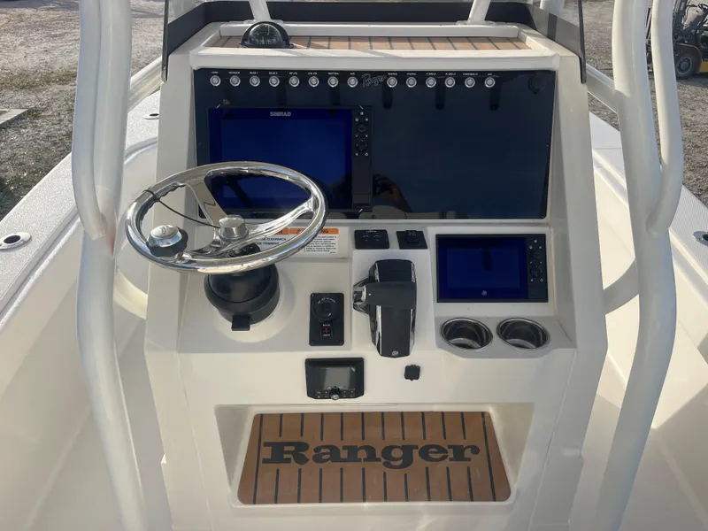 Slide: The Image of 2024 Ranger 2600 Bay boat console with steering wheel and electronic displays. - 2