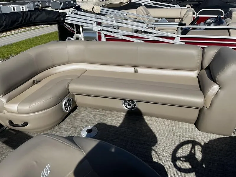 Slide: The Image of 2024 Ranger Reata 200C pontoon boat with beige seating and speaker system. - 3