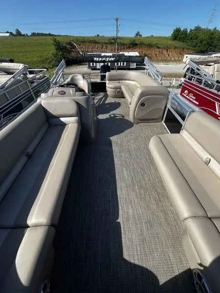 Slide: The Image of 2024 Ranger Reata 200C pontoon boat with spacious seating and modern design. - 7